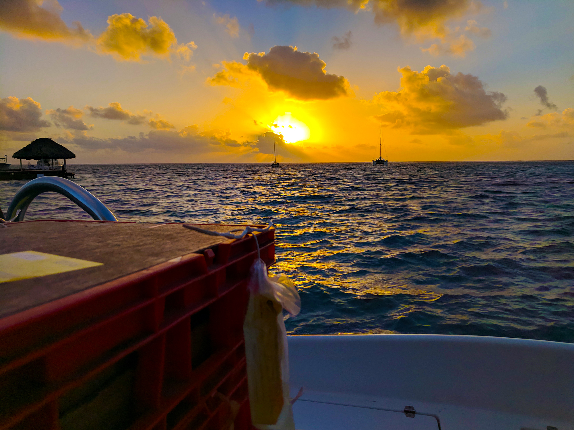 sunrise over caribbean sea from ferry in san pedro belize